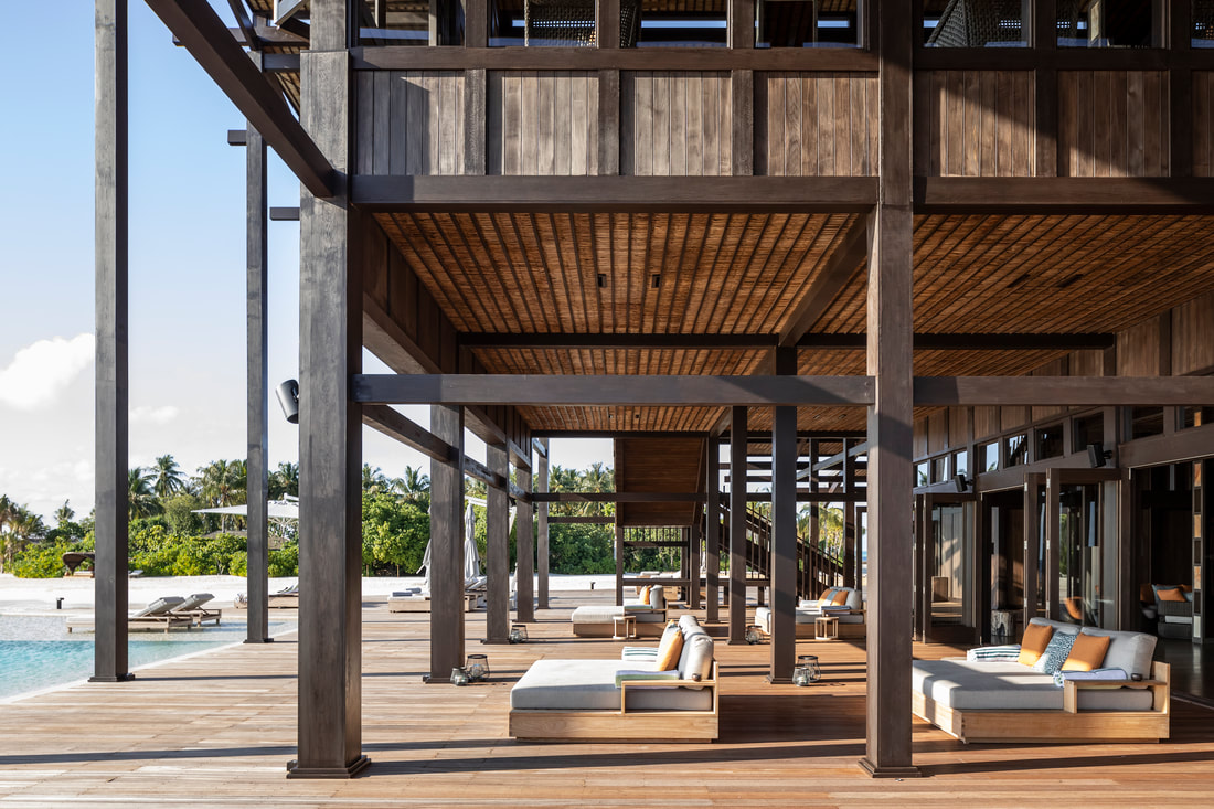 Natural wood infinity pool deck at a high end luxury beach resort