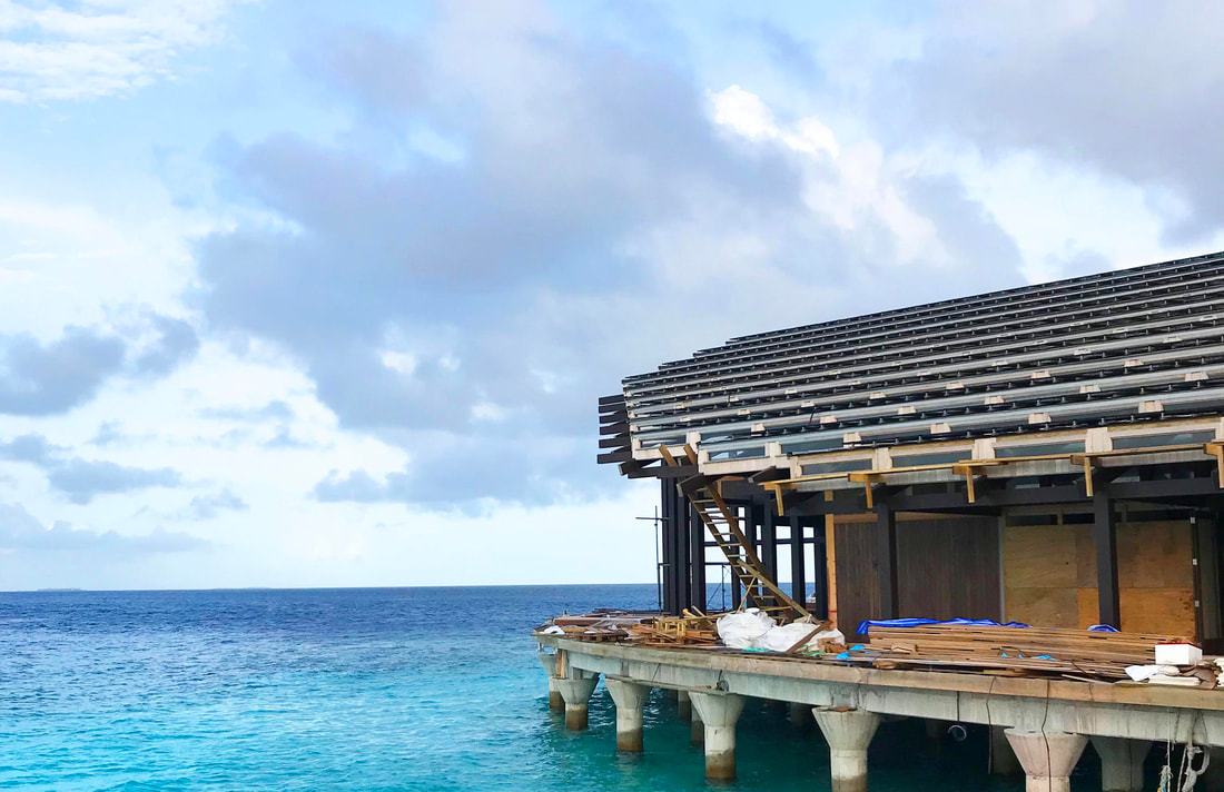 Solar panels on an above water complex overlooking the clear horizon