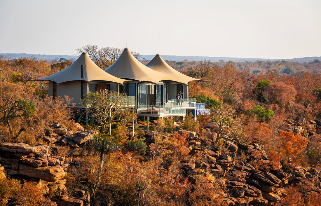 Sustainable eco hotel safari with a pathway shaded by solar panels, low impact tent villas